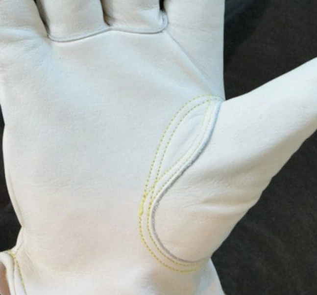Macro shot of double-stitched Keystone Thumb inset on Ocean Gloves assembly model OG-101.
