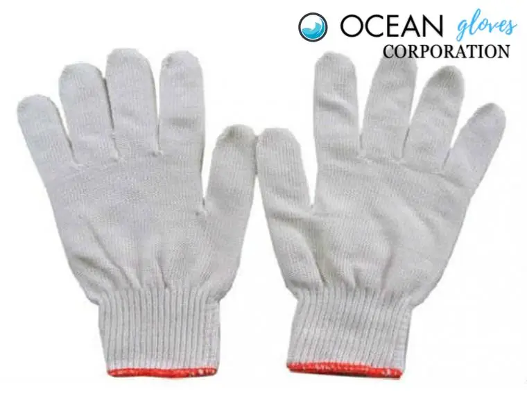 Ethically-Made White Cotton Work Gloves by Ocean Gloves White cotton work gloves from manufacturer Ocean Gloves Corporation with red overlock hem.